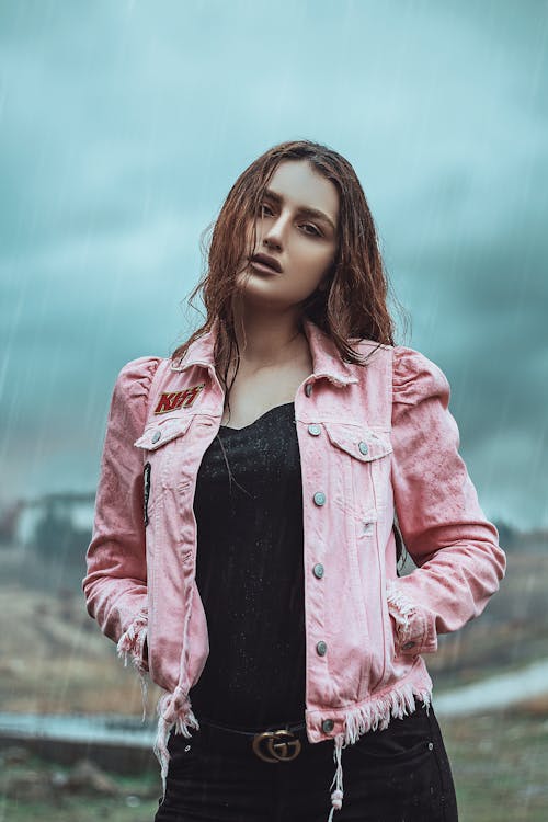 A Woman in Pink Jacket Standing in the Rain