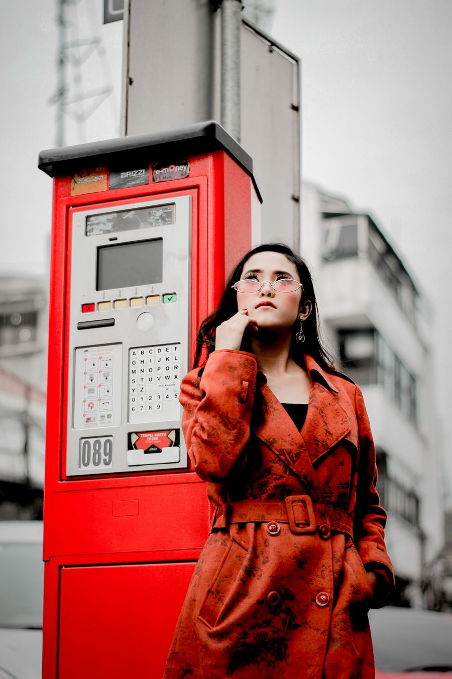 Woman in a red coat in an urban setting