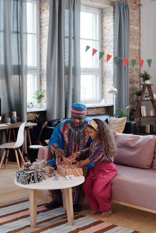 Free Photo Of Father And Daughter Wrapping Gifts Together Stock Photo