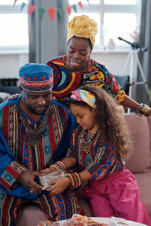 Free Photo Of Family Happily Sitting On A Sofa Stock Photo