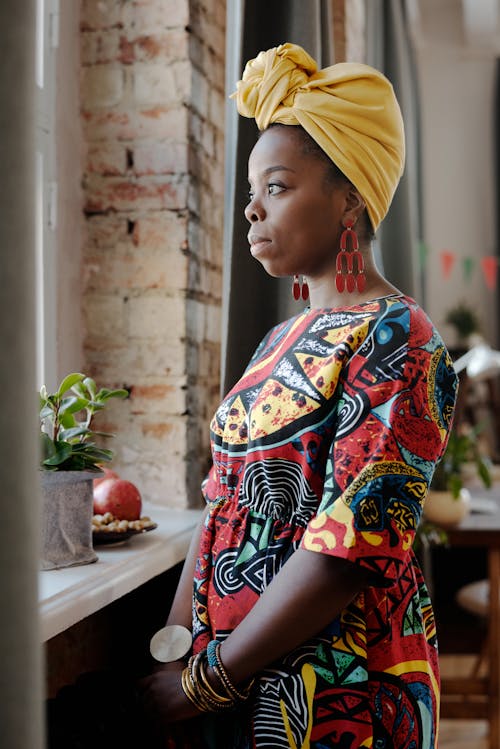 Photo Of Woman Standing Beside Window