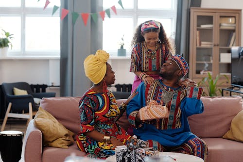 Photo Of Family Seated Together On The Couch