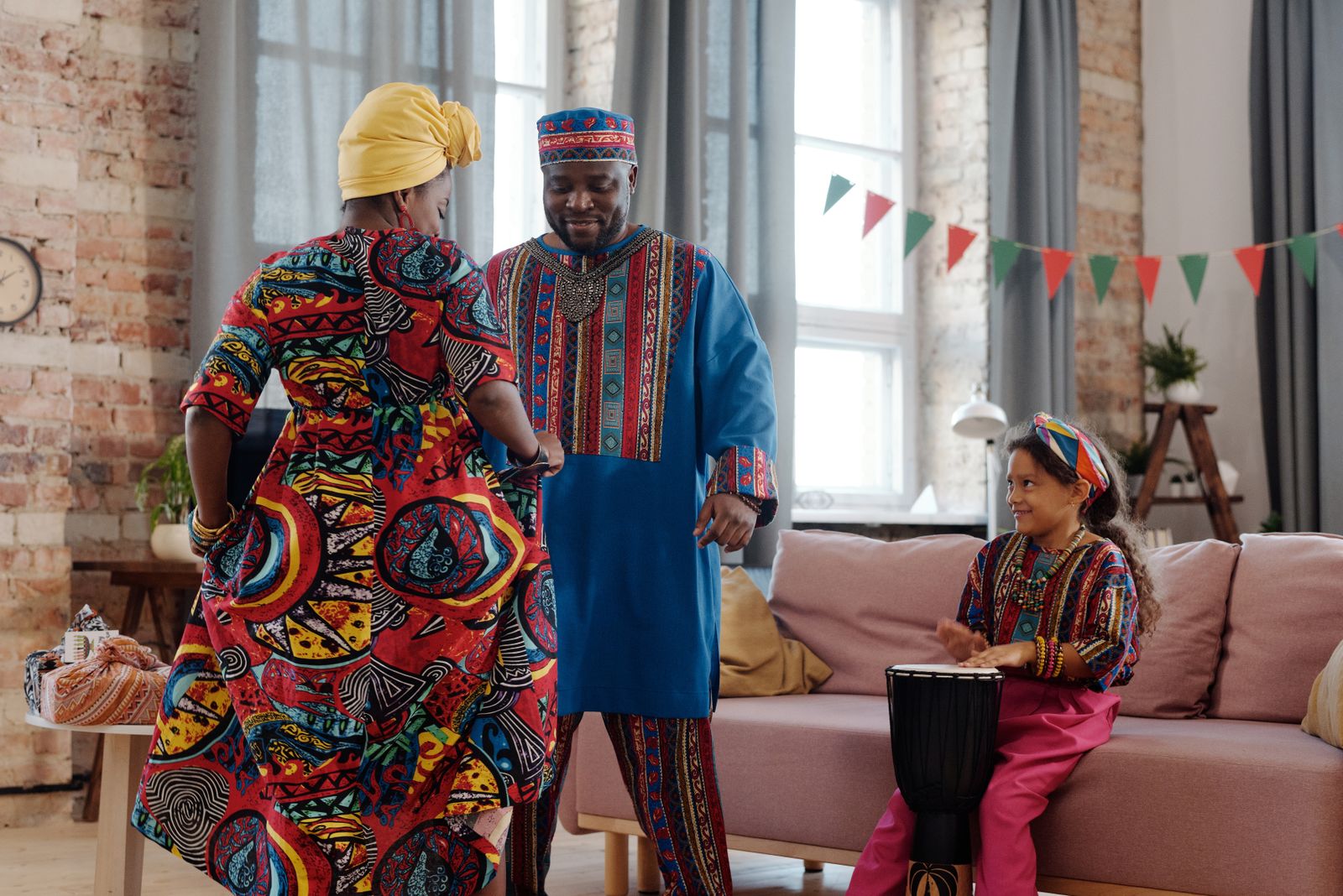 Parents and children dancing together happily in a living room
