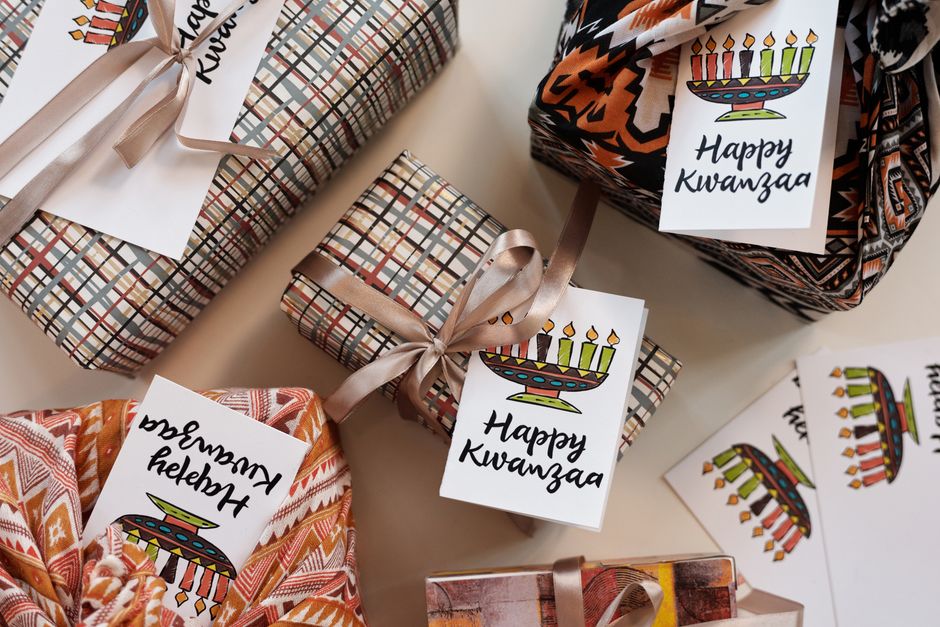 Beautifully wrapped Kwanzaa gifts with kinara-themed tags and traditional patterns.