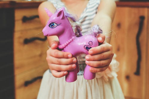 Child holding unicorn toy