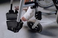 Person in White Pants Riding on Black and Gray Stationary Bike