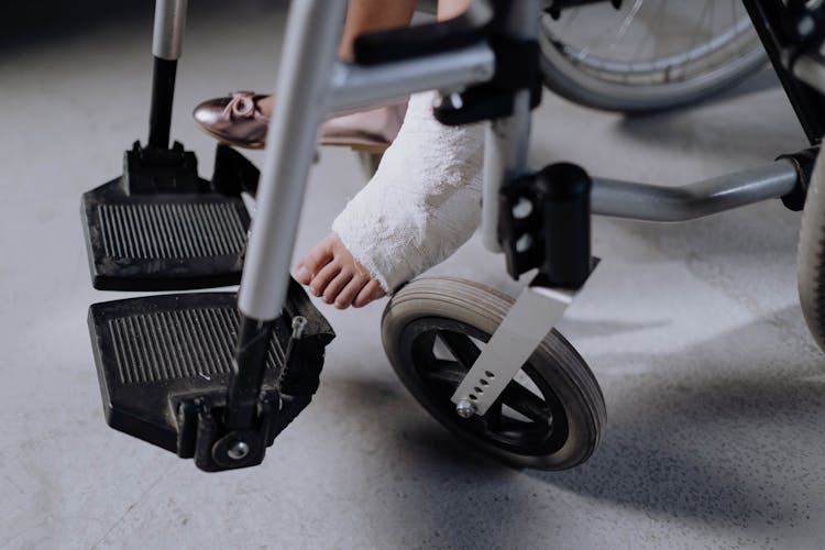 Injured Girl Sitting On A Wheelchair