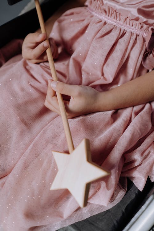 Free A Girl Wearing a Pink Dress Holding a Magic Wand Stock Photo
