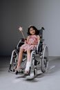 Woman in Orange Dress Sitting on Wheel Chair