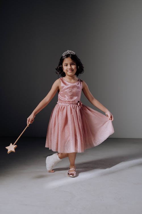 Free A Girl in Pink Dress Doing a Curtsy Stock Photo