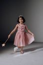 A Girl in Pink Dress Doing a Curtsy