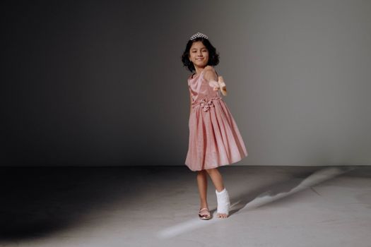 Girl in Pink Dress Standing on White Floor