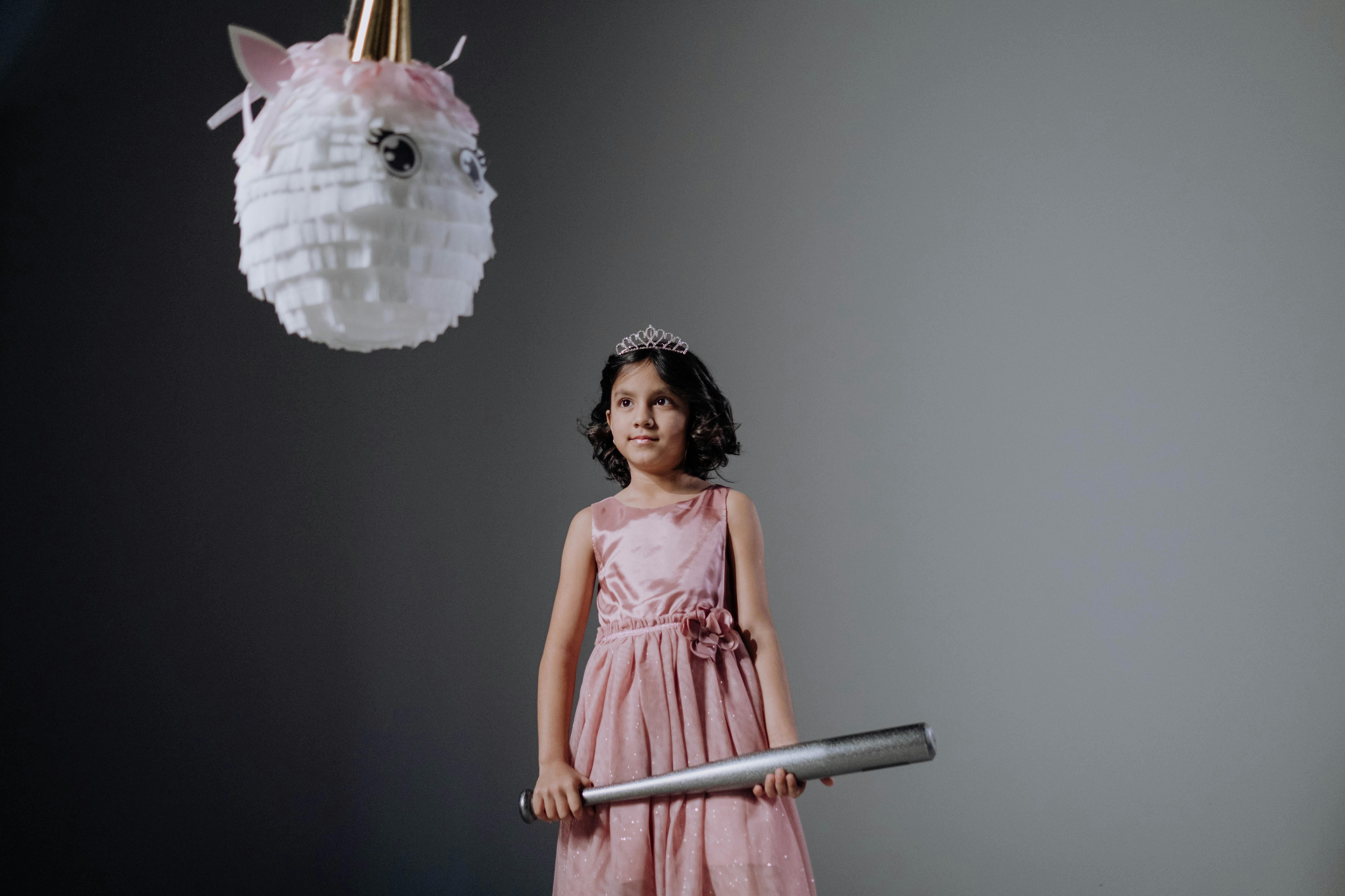 woman in pink sleeveless dress holding white and pink floral hand fan