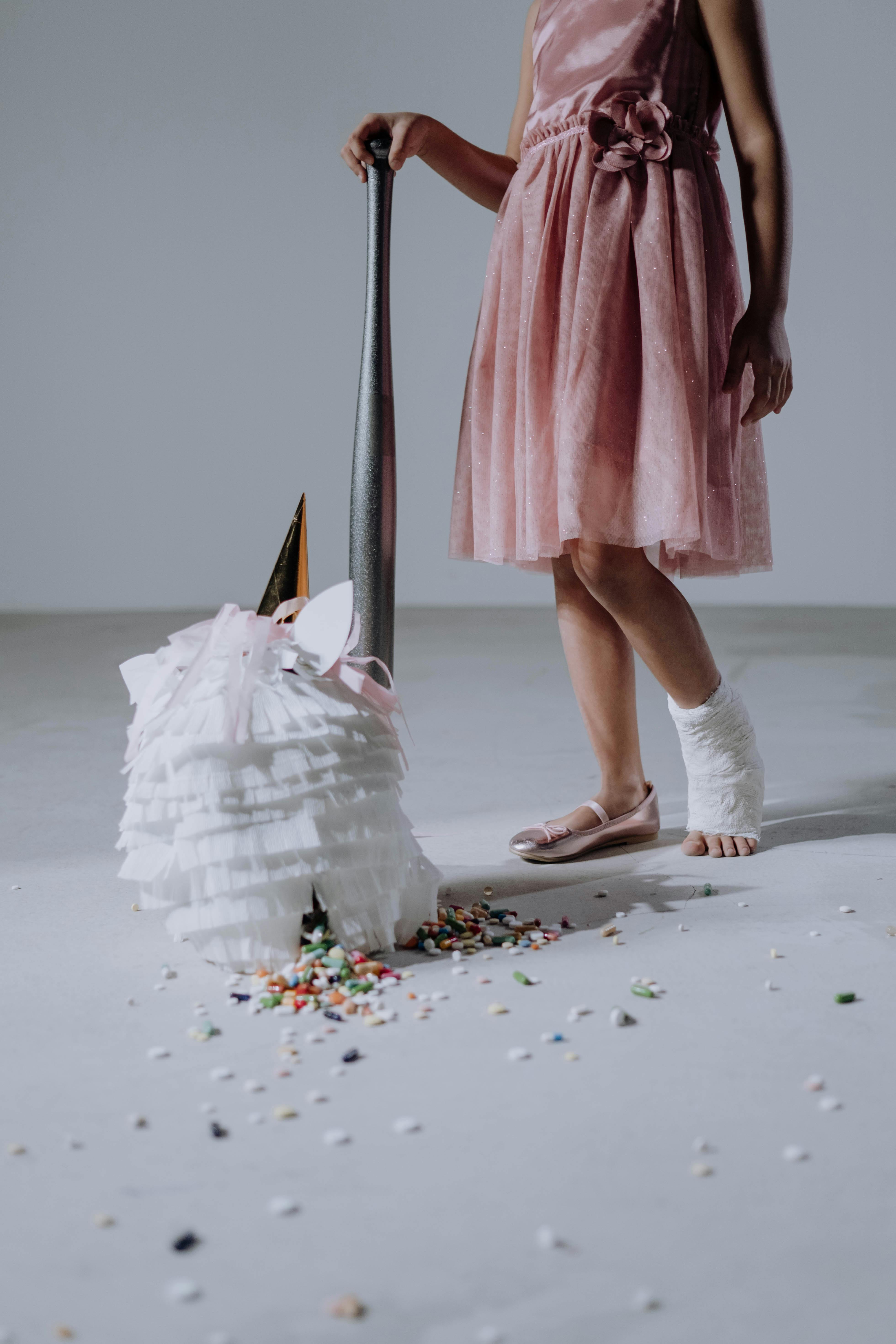 woman in pink dress and white boots standing on white snow