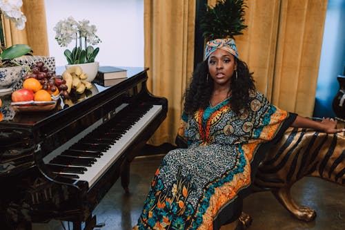 Free Photo Of Woman Sitting In Front Of Piano Stock Photo