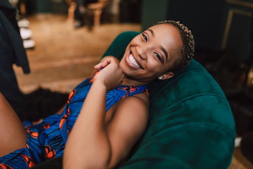 Free Photo Of Woman Laying On A Suede Couch Stock Photo