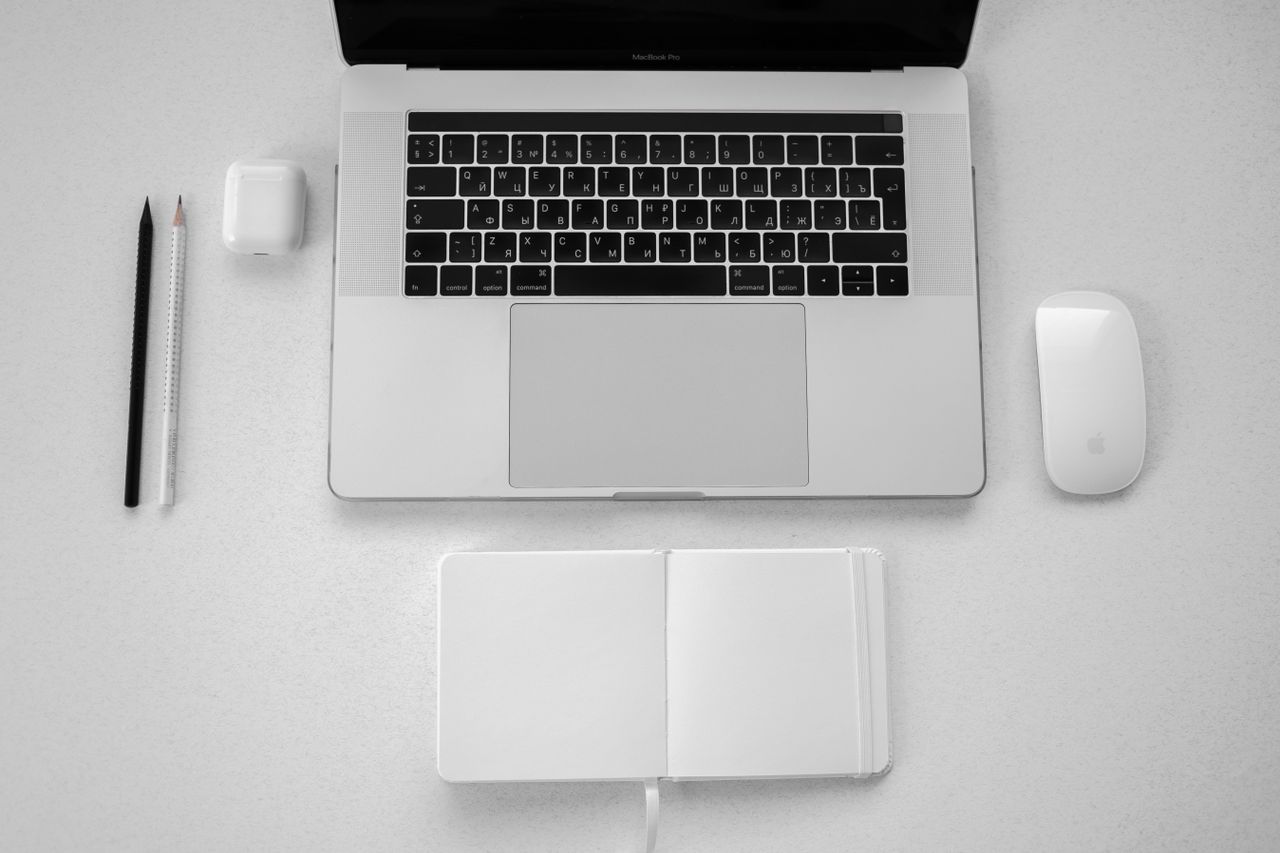 a minimalist top down view of a workspace featuring a laptop notebook