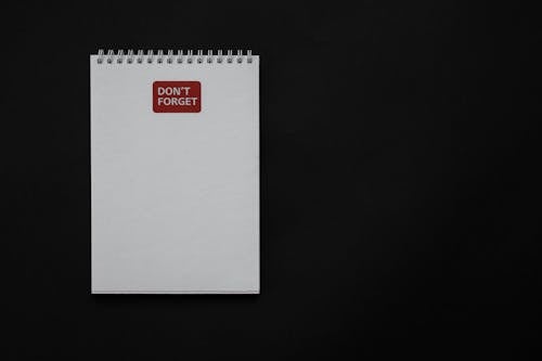 Free Notepad on Black Surface Stock Photo