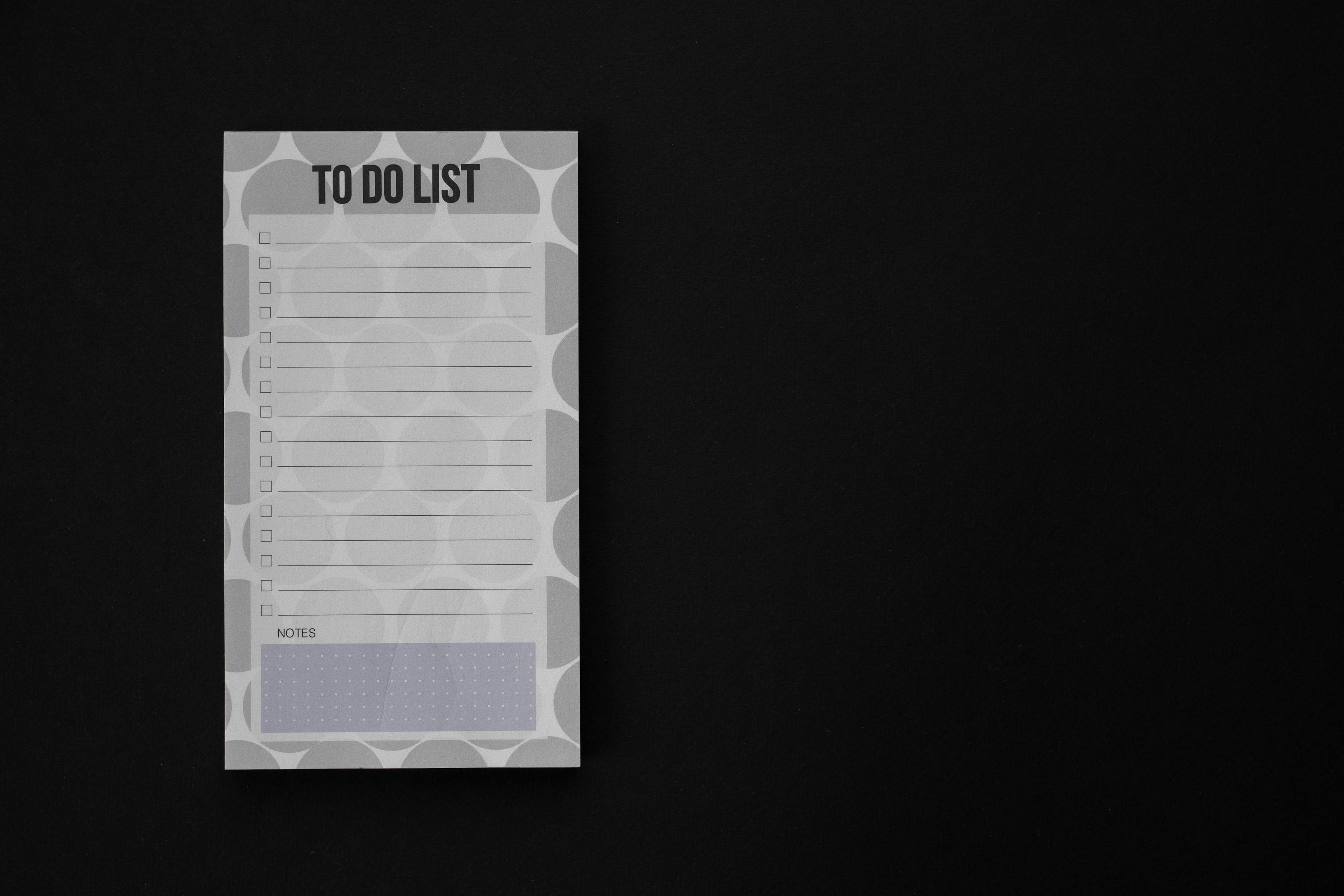 Close-Up Shot of a To Do List on a Black Surface