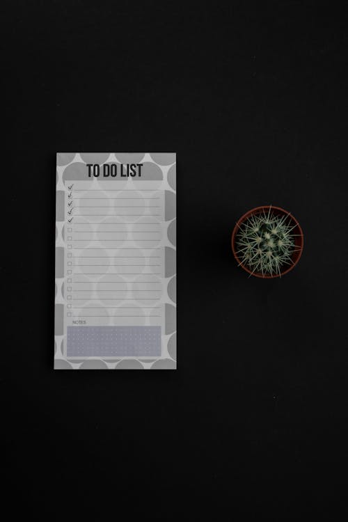 Free Close-Up Shot of a To Do List on a Black Surface Stock Photo