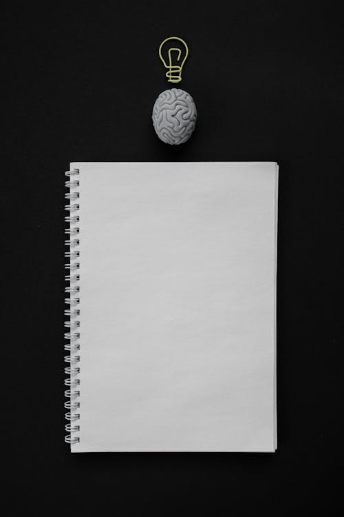 Close-Up Shot of an Empty Notebook on a Black Surface
