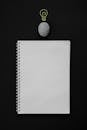 Close-Up Shot of an Empty Notebook on a Black Surface