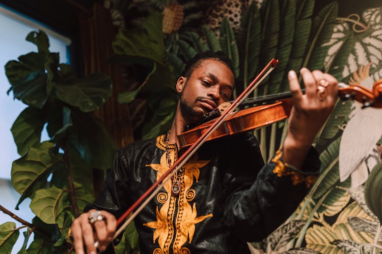 Close-Up Photo Of Man Playing Violin