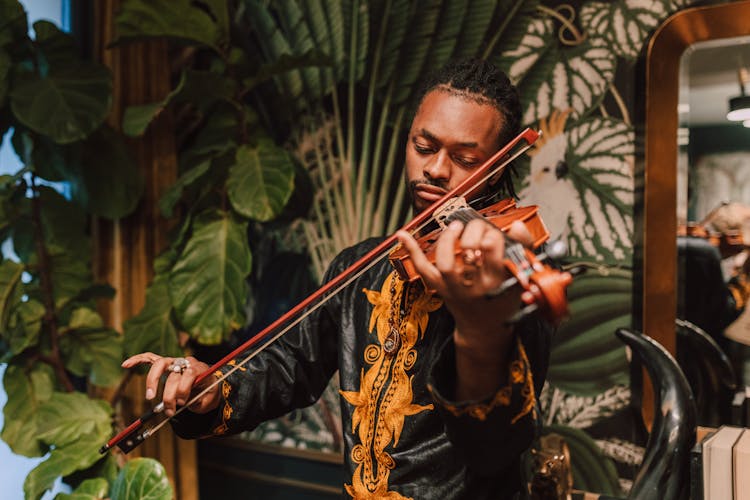 Man In Black Long Sleeves Playing A Violin