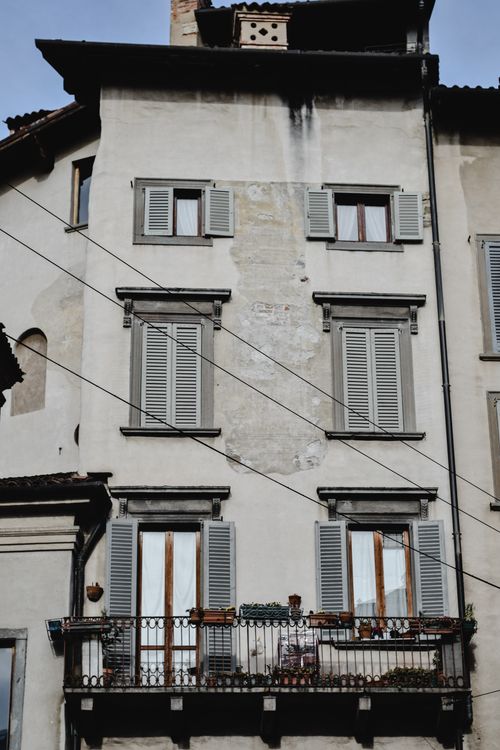 Free Charming exterior of a historic building in Bergamo, Lombardy with classic shutters and a rustic balcony. Stock Photo