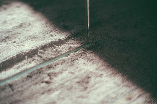 Closeup of of soft surface of light colored carpet with geometric lines as decor