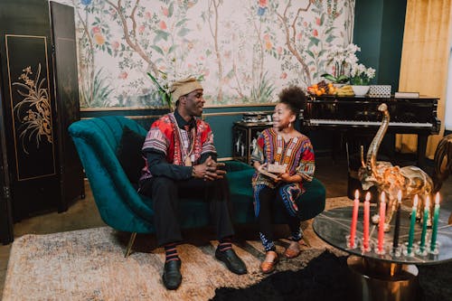 Free Man And Woman Having A Conversation While Sitting On A Couch Stock Photo