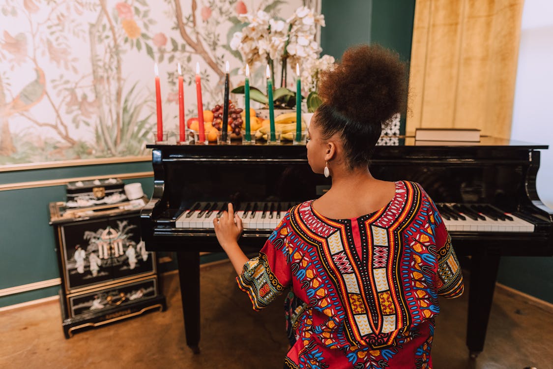 Free Woman In Red Kaftan Dress Playing Piano Stock Photo