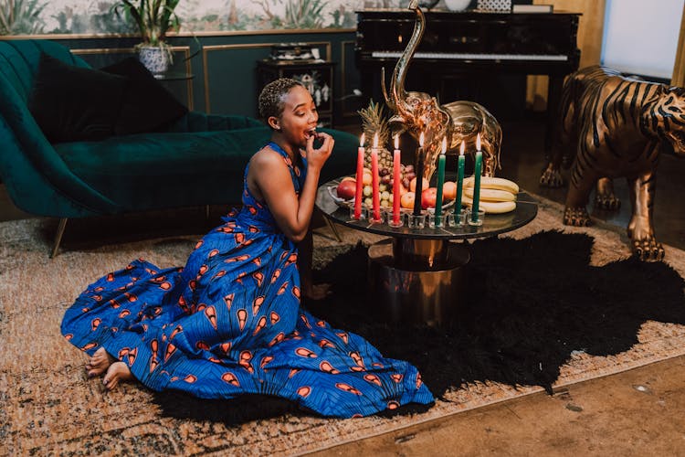 Woman In Blue Kaftan Dress Eating Fruits