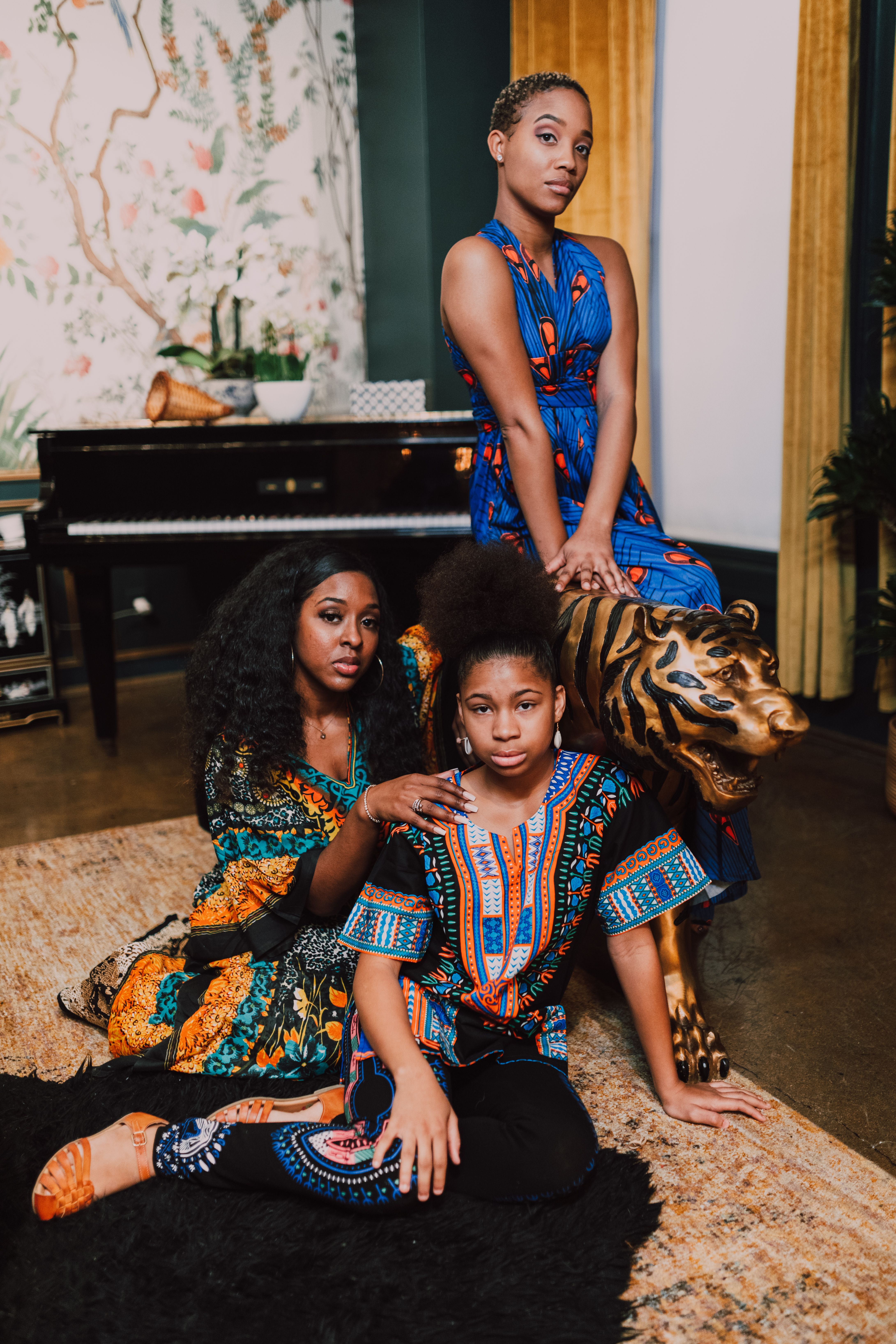 Three Women Sitting Beside A Tiger Statue · Free Stock Photo