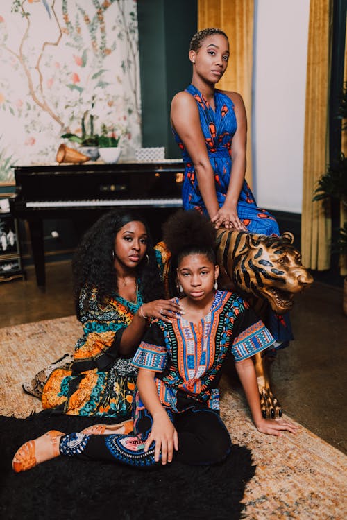 Free Three Women Sitting Beside A Tiger Statue Stock Photo