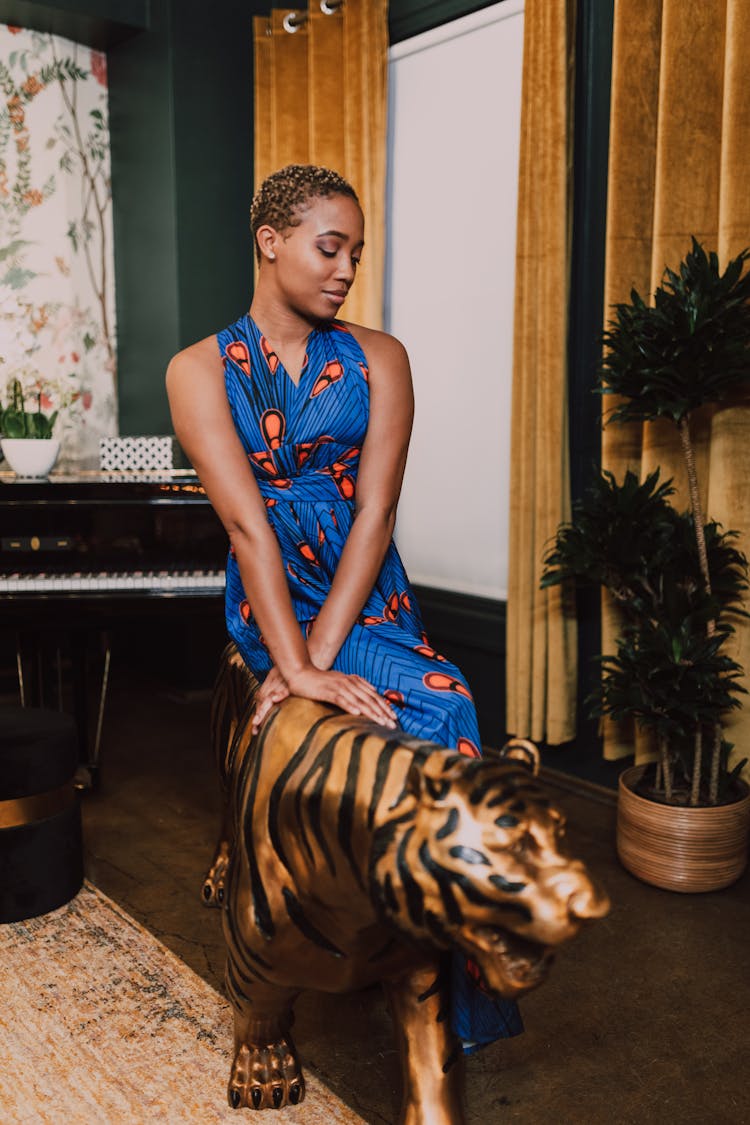 Woman Sitting On A Tiger Figurine