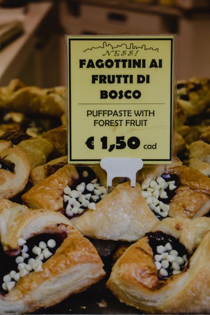 Freshly baked puff pastries with forest fruit filling at an Italian bakery in Bergamo.