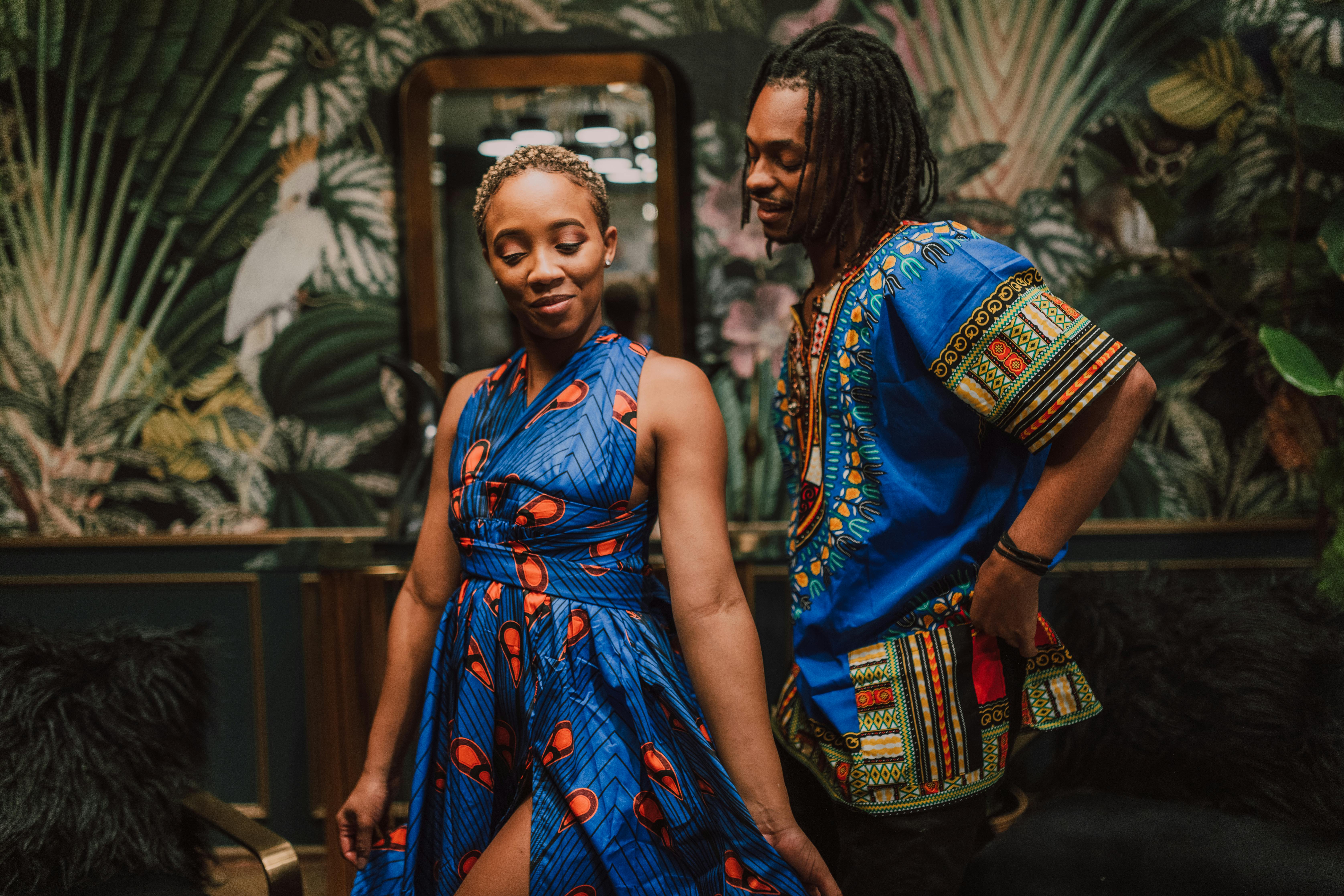 woman in blue dress dancing with a man in blue shirt