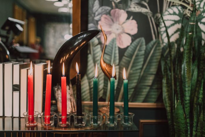Lit candles arranged on a glass candle holder
