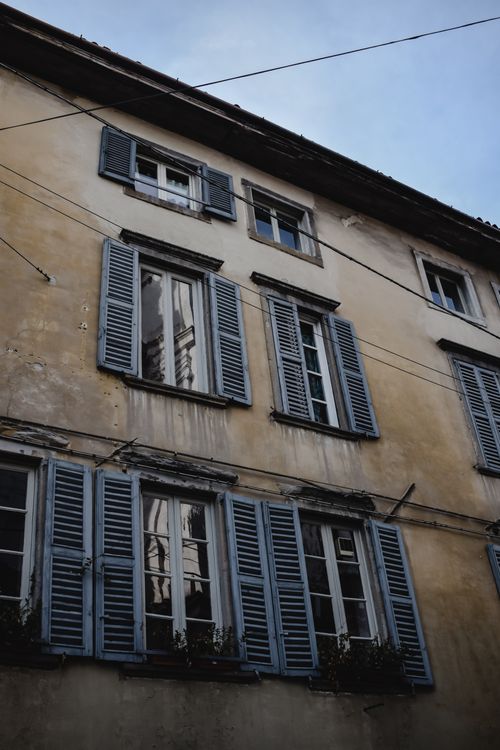 Free A historic building facade with weathered shutters in Bergamo, Italy. Stock Photo