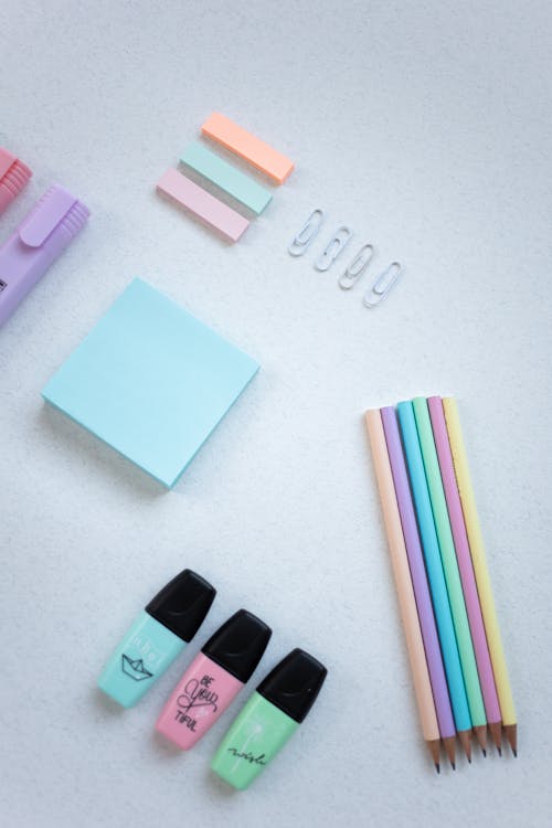 Free Coloring Materials and Sticky Notes on White Surface Stock Photo