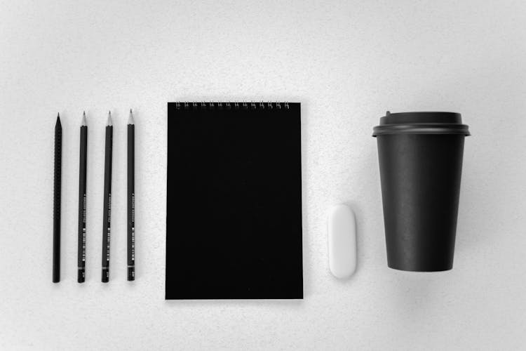 Black Stationery And Pencils A White Surface