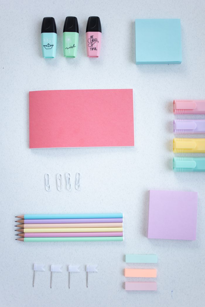 Pastel desk objects arranged in a flat lay, photo by Katrin Bolovtsova on Pexels