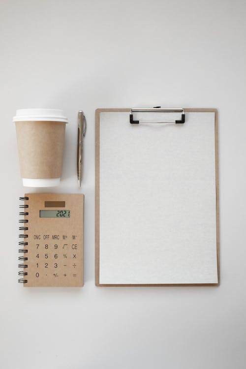 Free Coffee Cup and a Calculator Stock Photo