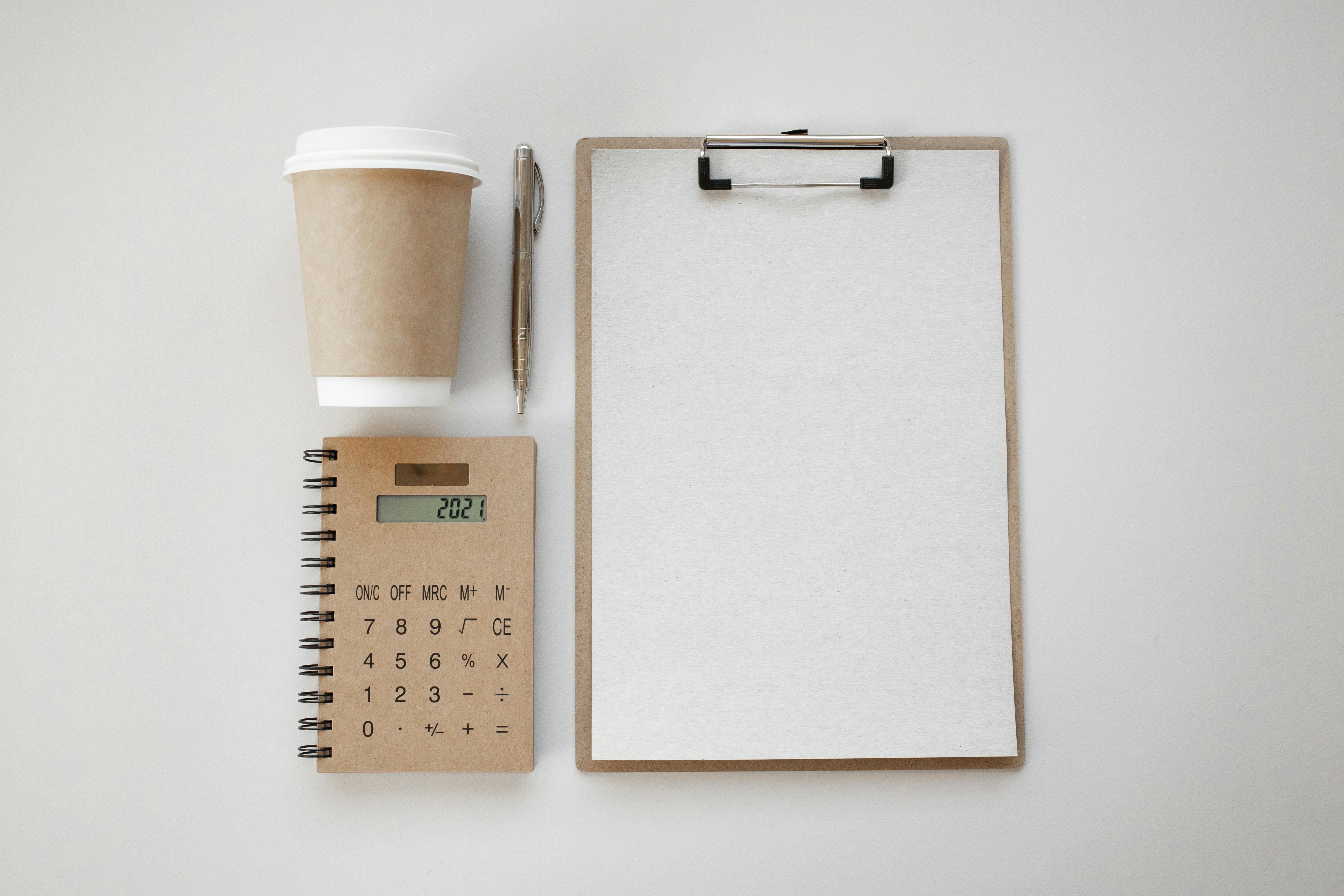 stationery and coffee on white background