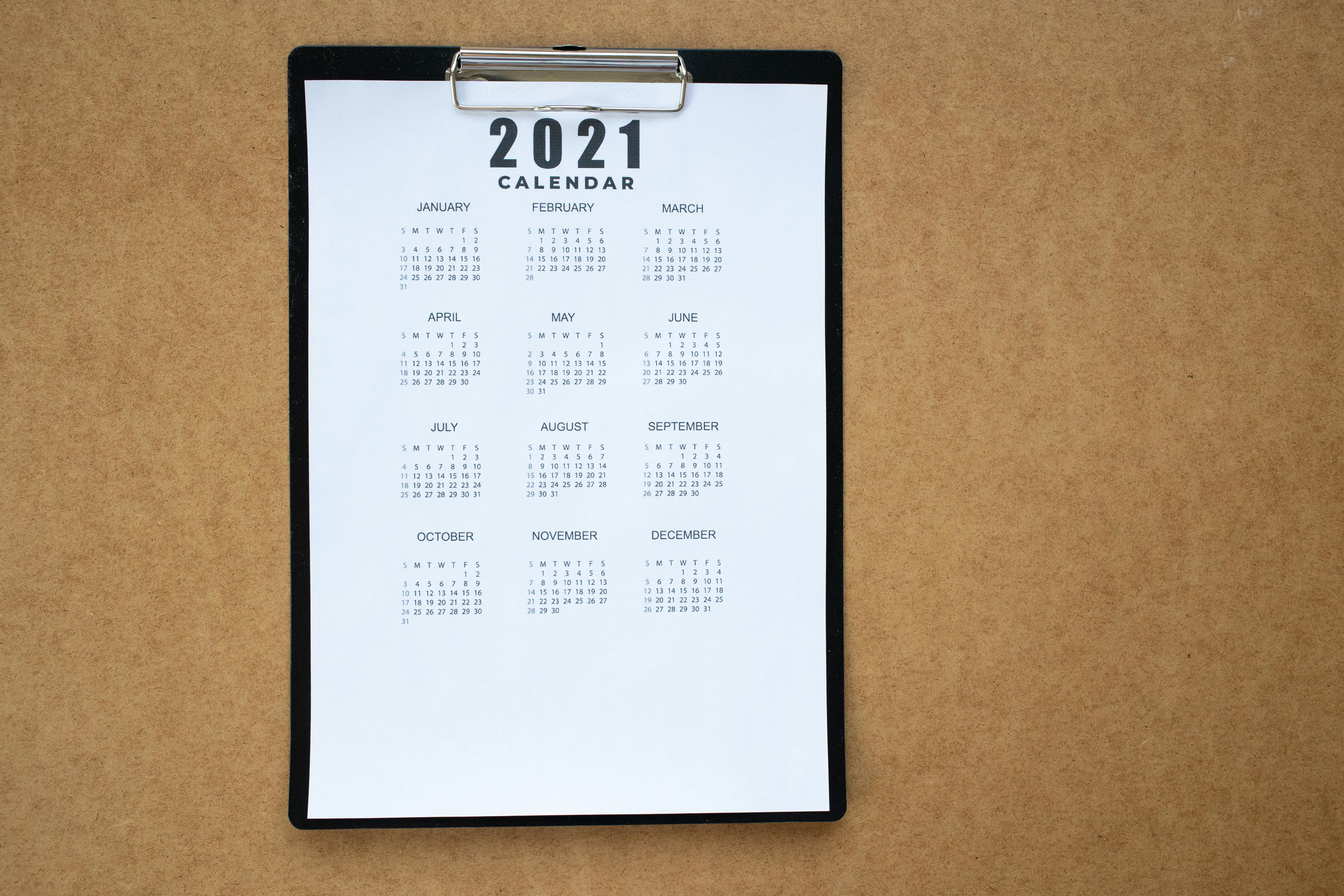 white and black calendar on brown surface