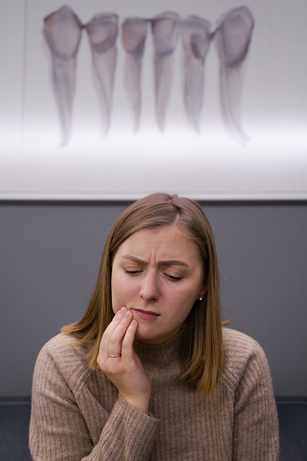 A Woman in Pain Holding Her Cheek