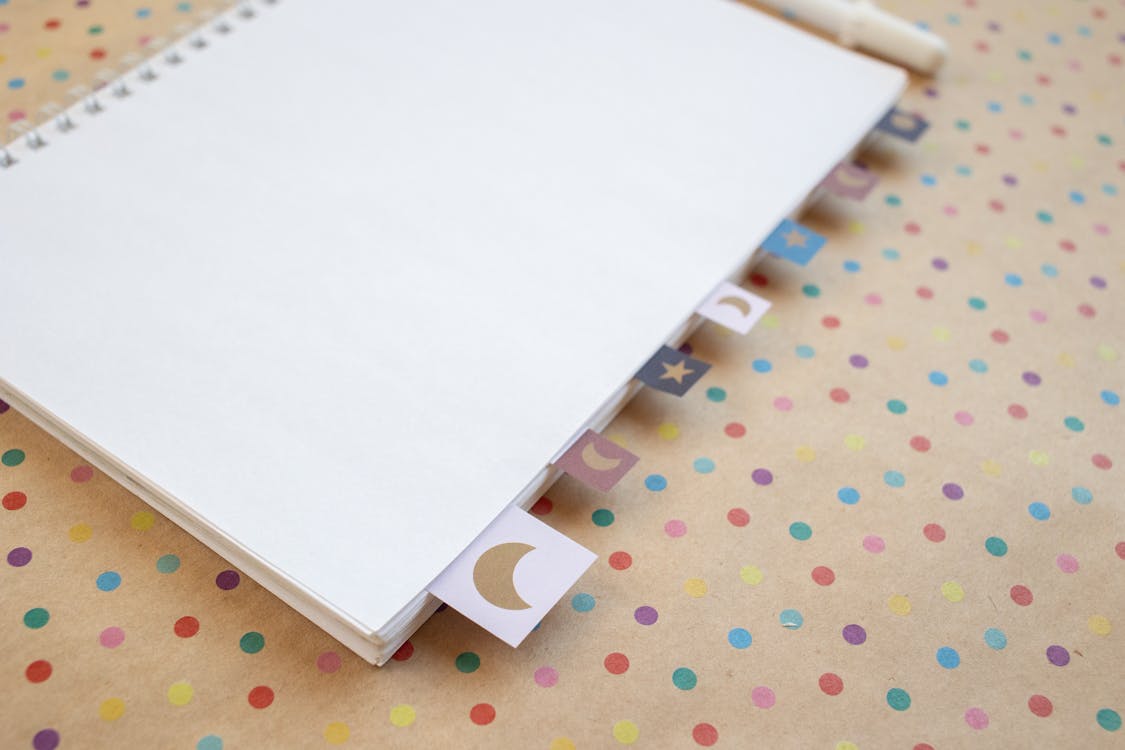 A White Notebook on a Polka Dot Surface