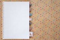 White Spiral Notebook on a Polka Dot Background