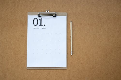 Free Calendar on Clipboard and a Pencil Stock Photo